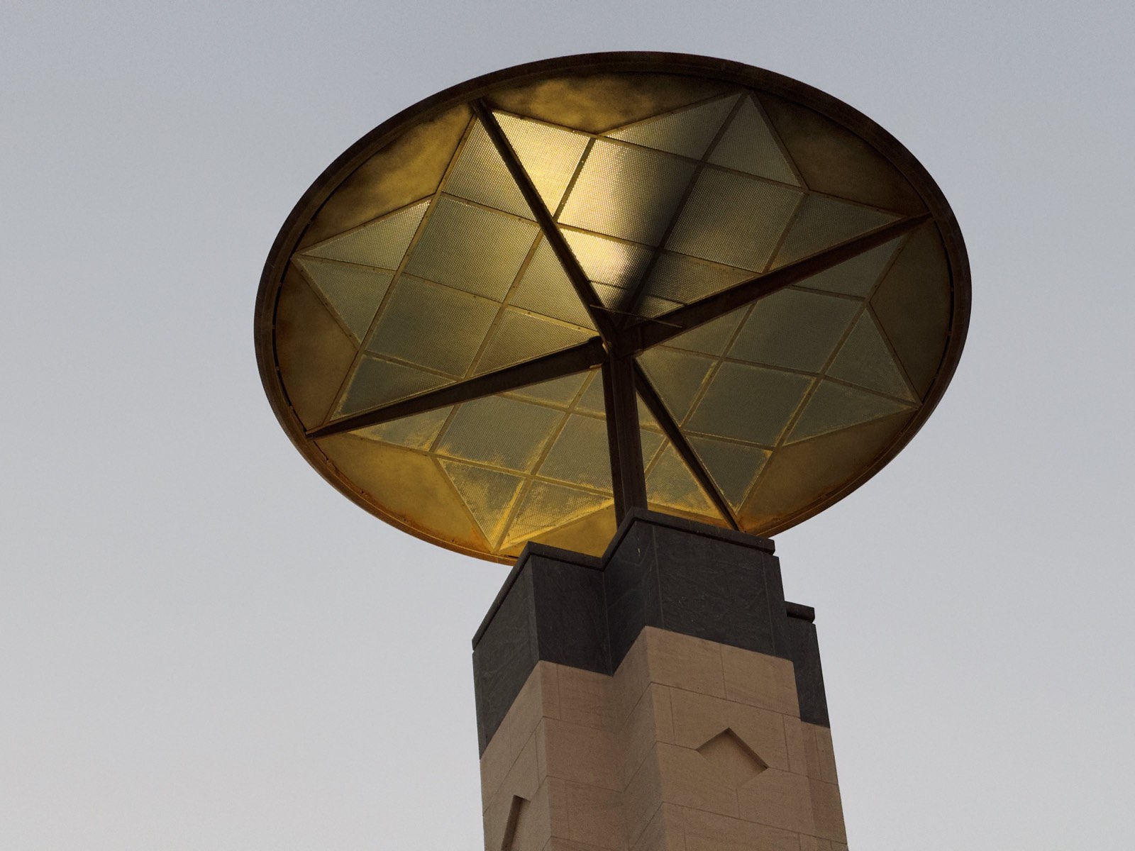 Warm light through a geometric ceiling fixture